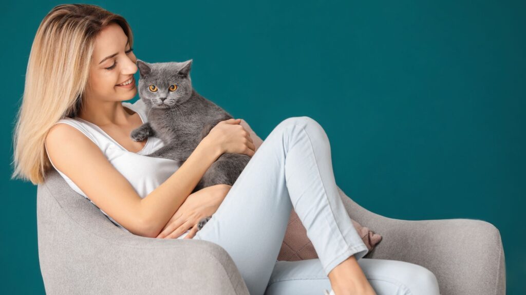 woman holding pet cat