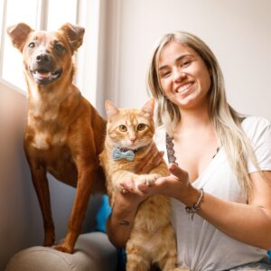 smiling pet sitter with cat and dog