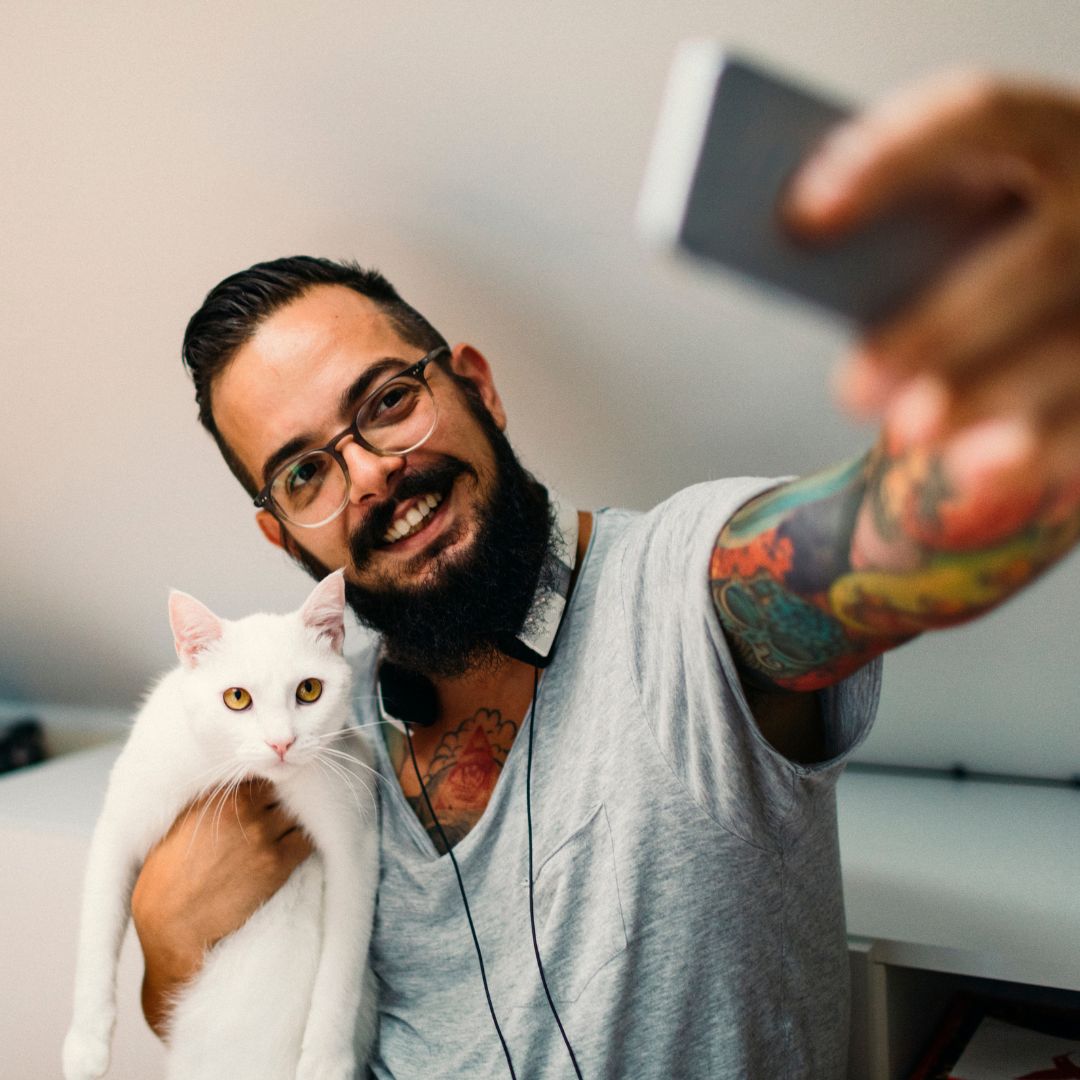 person taking selfie with cat