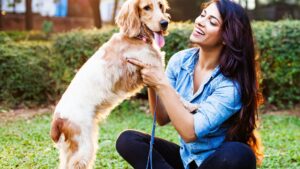 Person smiling with a dog outside