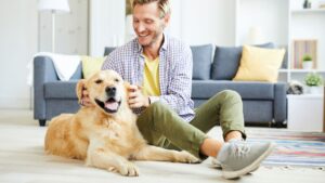 Person sitting on the floor with a dog