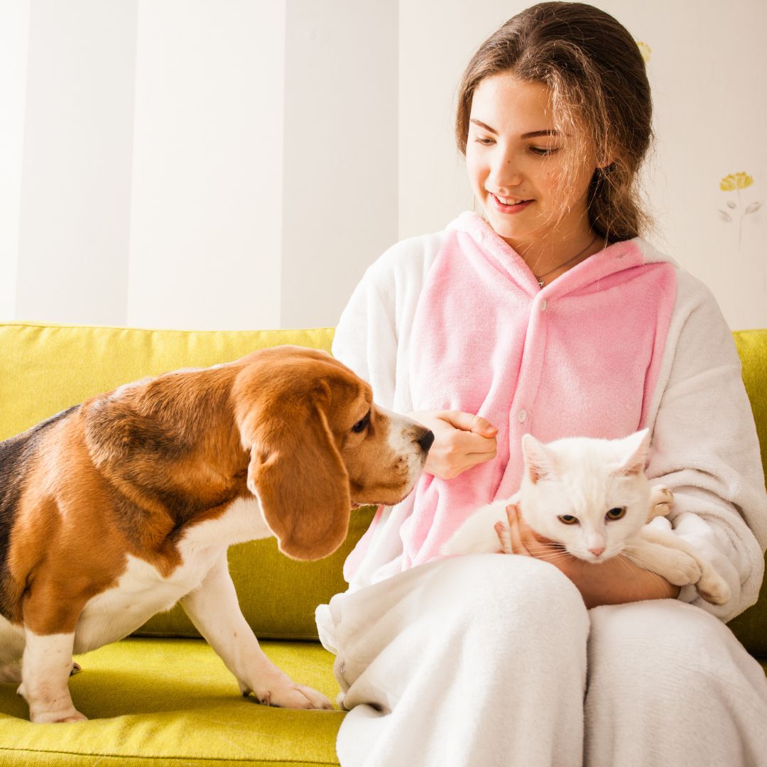 young woman with pets on couch