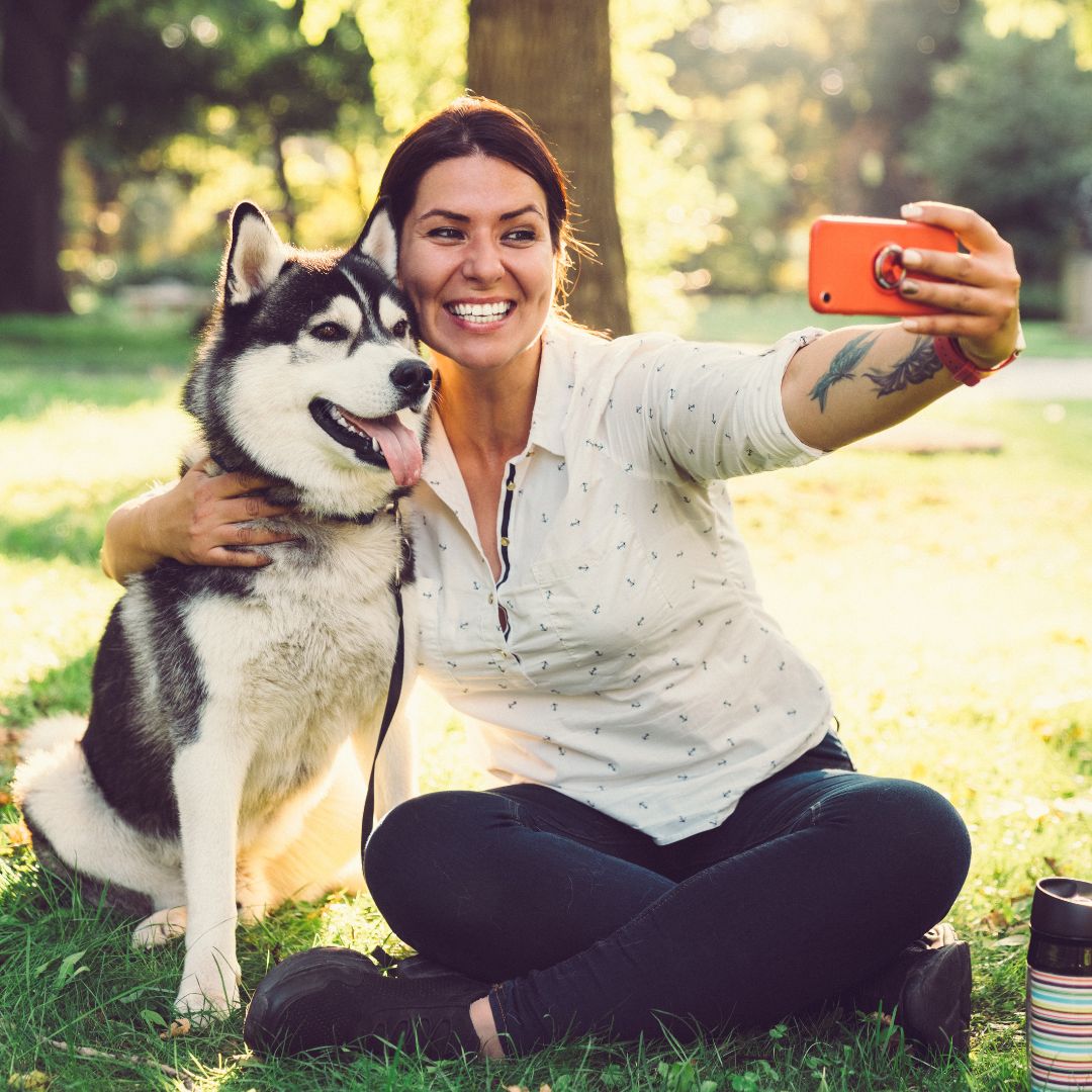 Girl taking a selfie with a dog