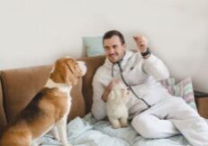 Man sitting on the couch with two dogs